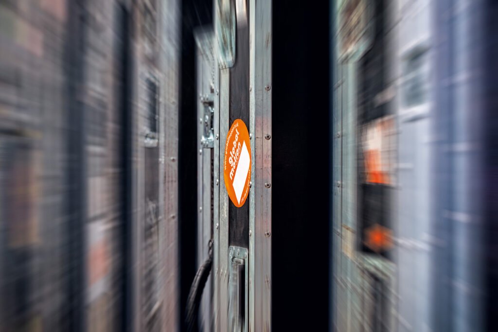 A blurry image of flight cases with an orange global motion sticker on it